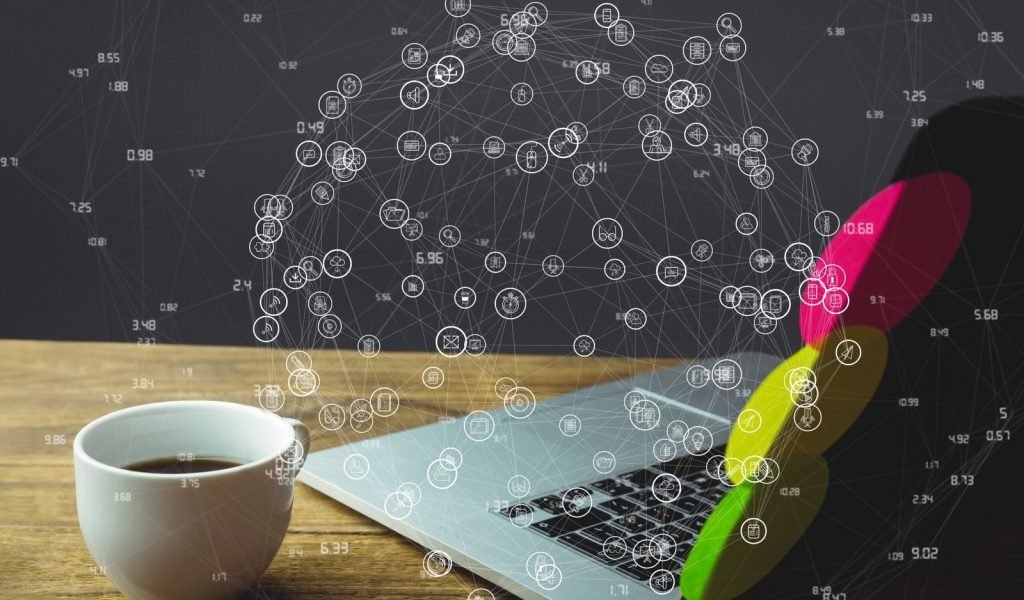 laptop-wooden-desk-with-social-media-diagram-1-scaled